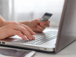 hands typing on a computer